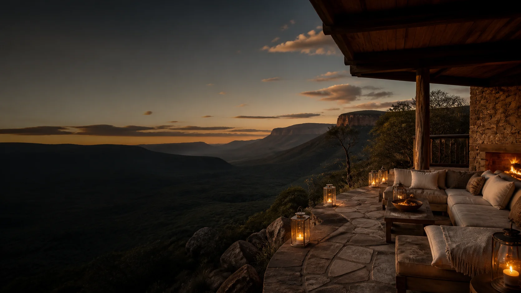 Private lodge terrace overlooking a South African mountain valley at dusk